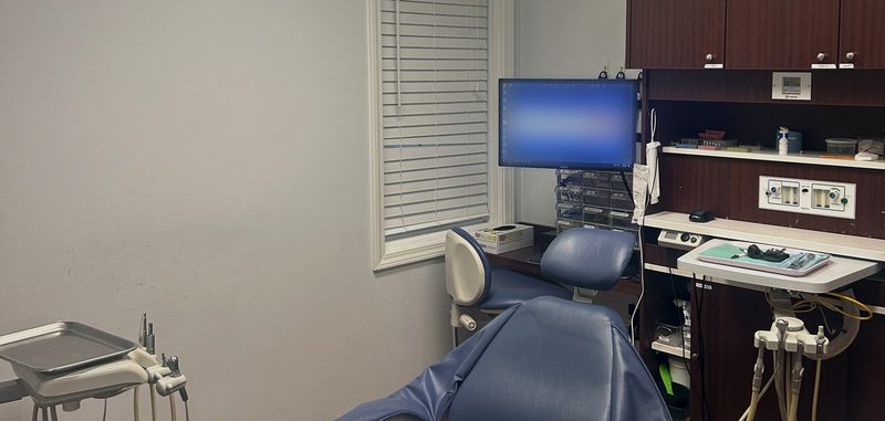 Treatment room with a patient chair and digital monitor