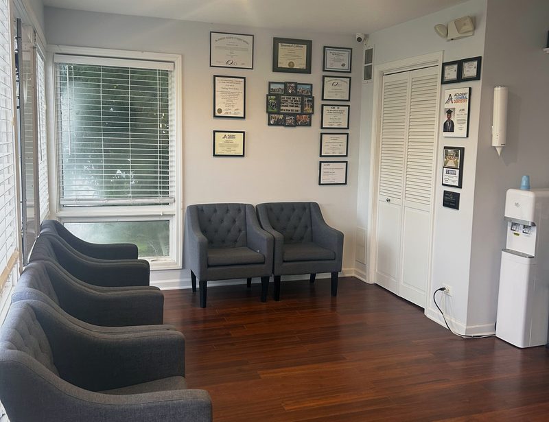 Waiting room with upholstered chairs and Dr. Moon's framed credentials